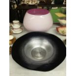 A LARGE PINK GLASS BOWL PLUS A LARGE BLACK AND SILVER BOWL