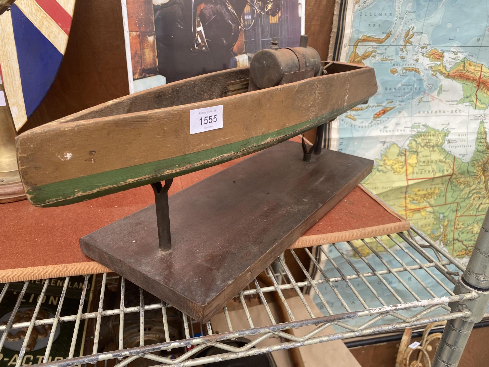 A VINTAGE WOODEN MODEL BOAT WITH STAND