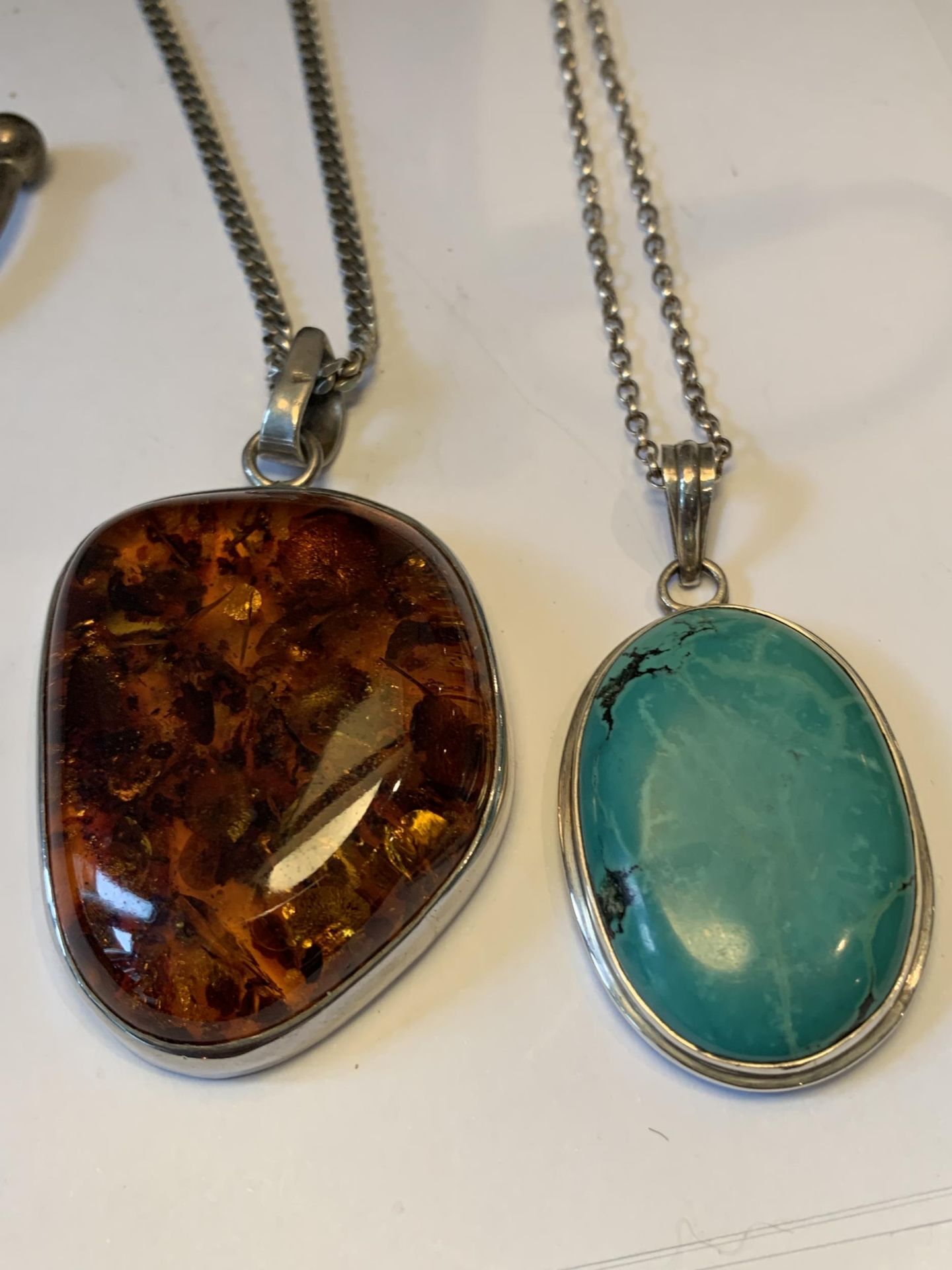 TWO SILVER NECKLACES WITH LARGE PENDANTS AND A SILVER BANGLE - Image 2 of 4