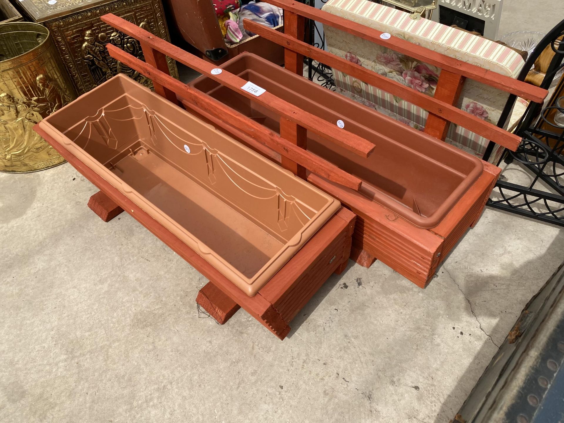 A PAIR OF WOODEN TROUGH PLANTERS WITH PLASTIC INSERTS AND TRELIS BACKS