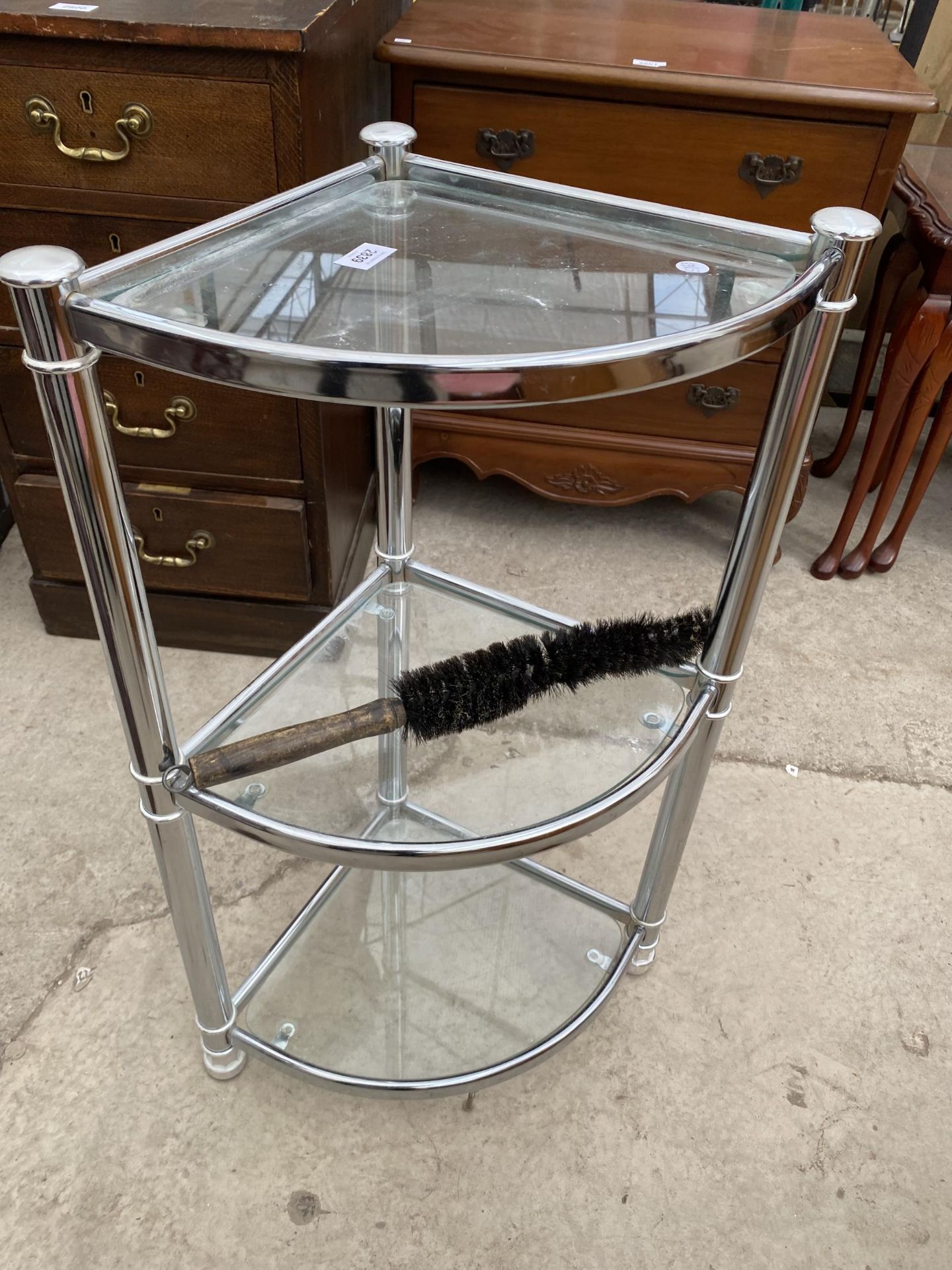 A MODERN POLISHED CHROME AND GLASS THREE TIER CORNER STAND