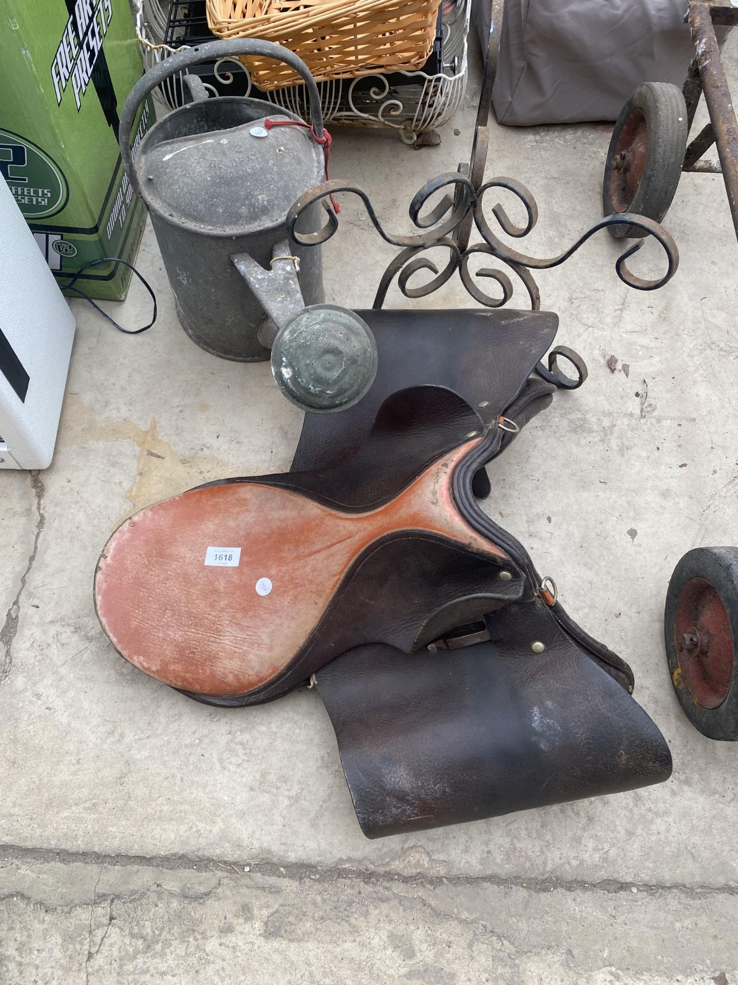AN ASSORTMENT OF VINTAGE ITEMS TO INCLUDE A PLANT STAND, A SADDLE AND A WATERING CAN