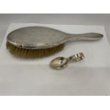 A HALLMARKED SILVER BABY'S SPOON AND SILVER BACKED BRUSH
