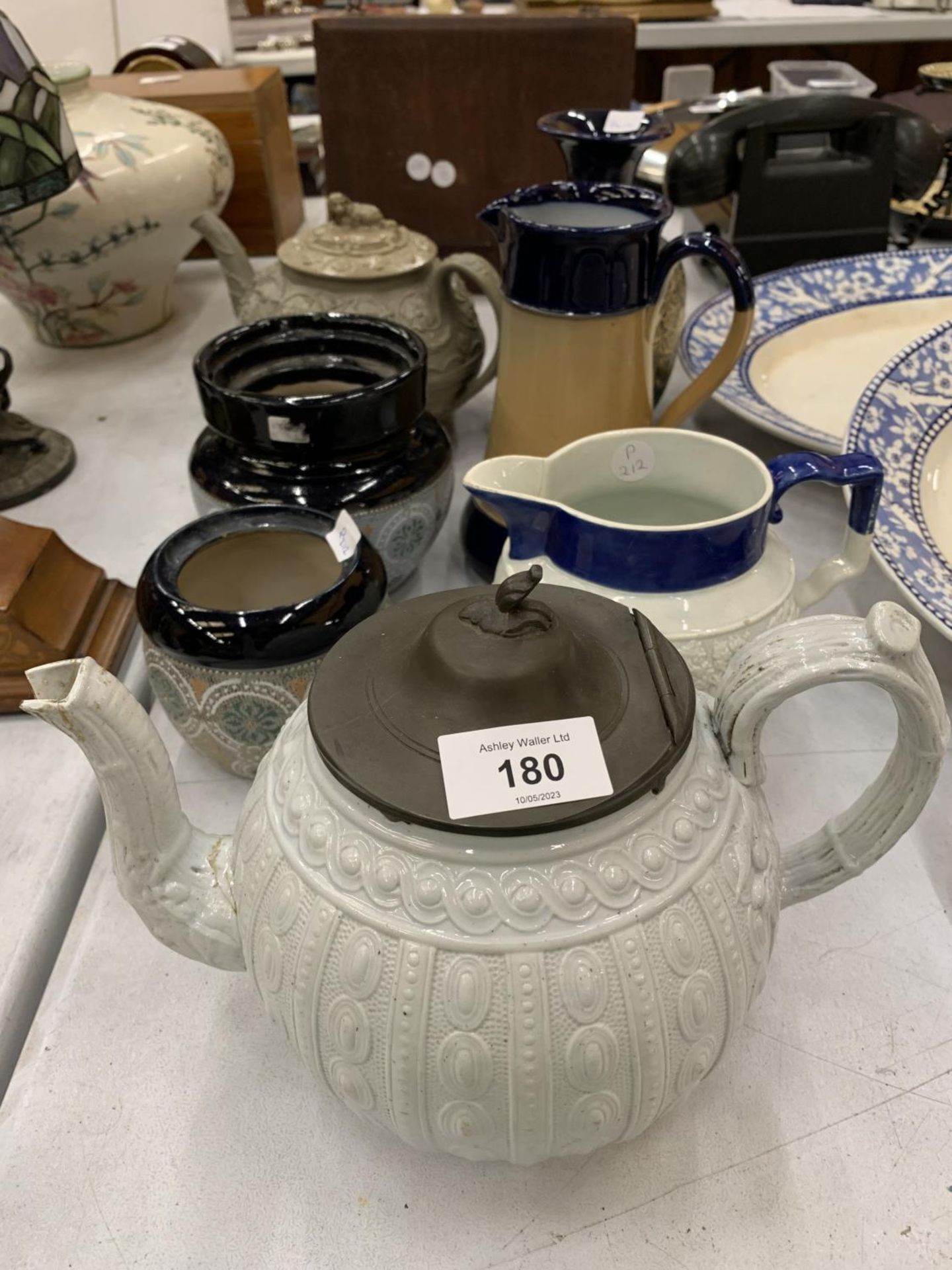 A COLLECTION OF STONEWARE ITEMS TO INCLUDE A ROYAL DOULTON JUG, DOULTON STYLE POTS, TEAPOTS, ETC