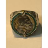 A LARGE RING WITH A FIVE CENT COIN ENGRAVED 'INDIAN HEAD NICKEL HONOURING THE AMERICAN WEST'