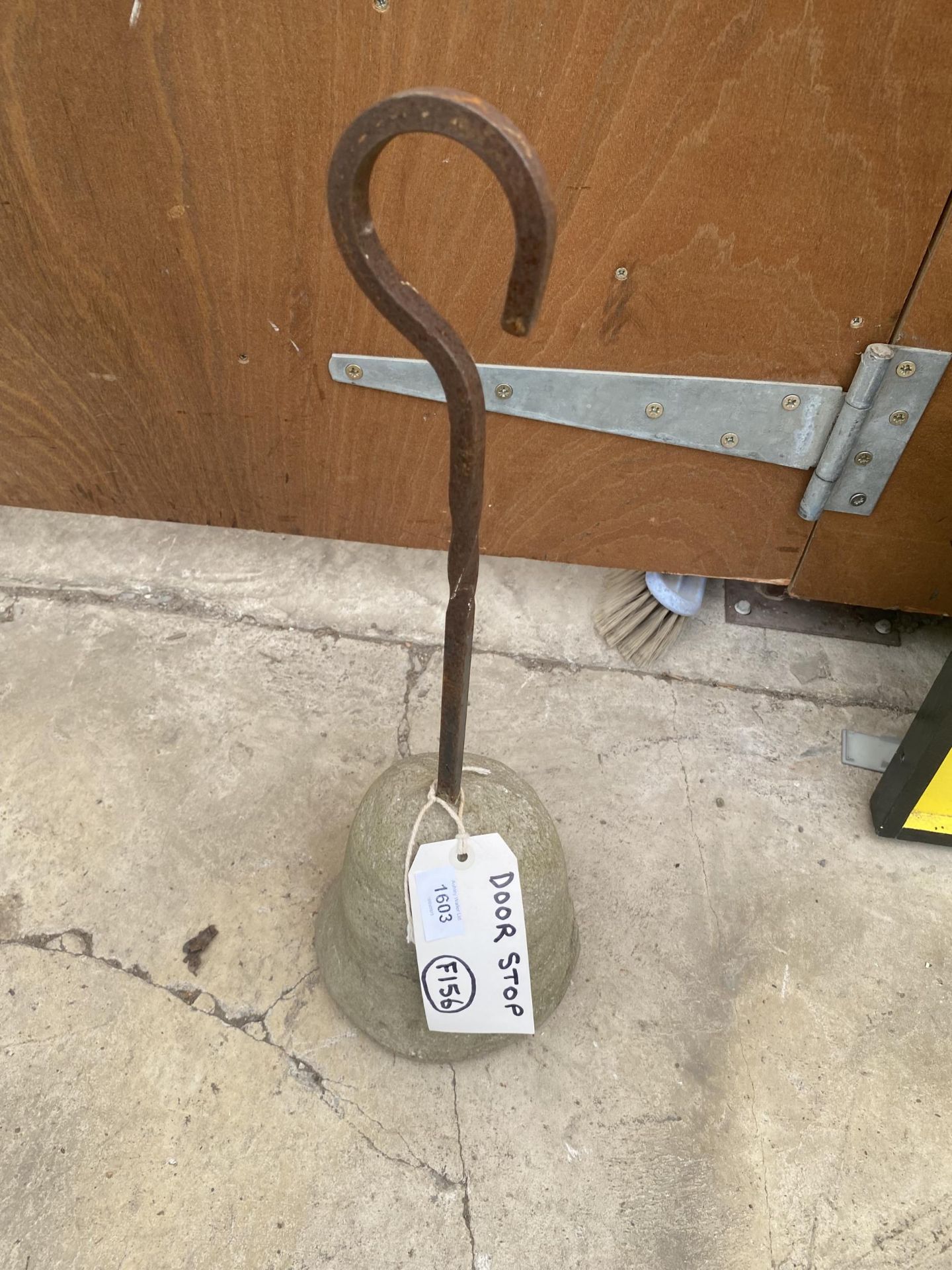 A METAL AND CONCRETE DOOR STOP