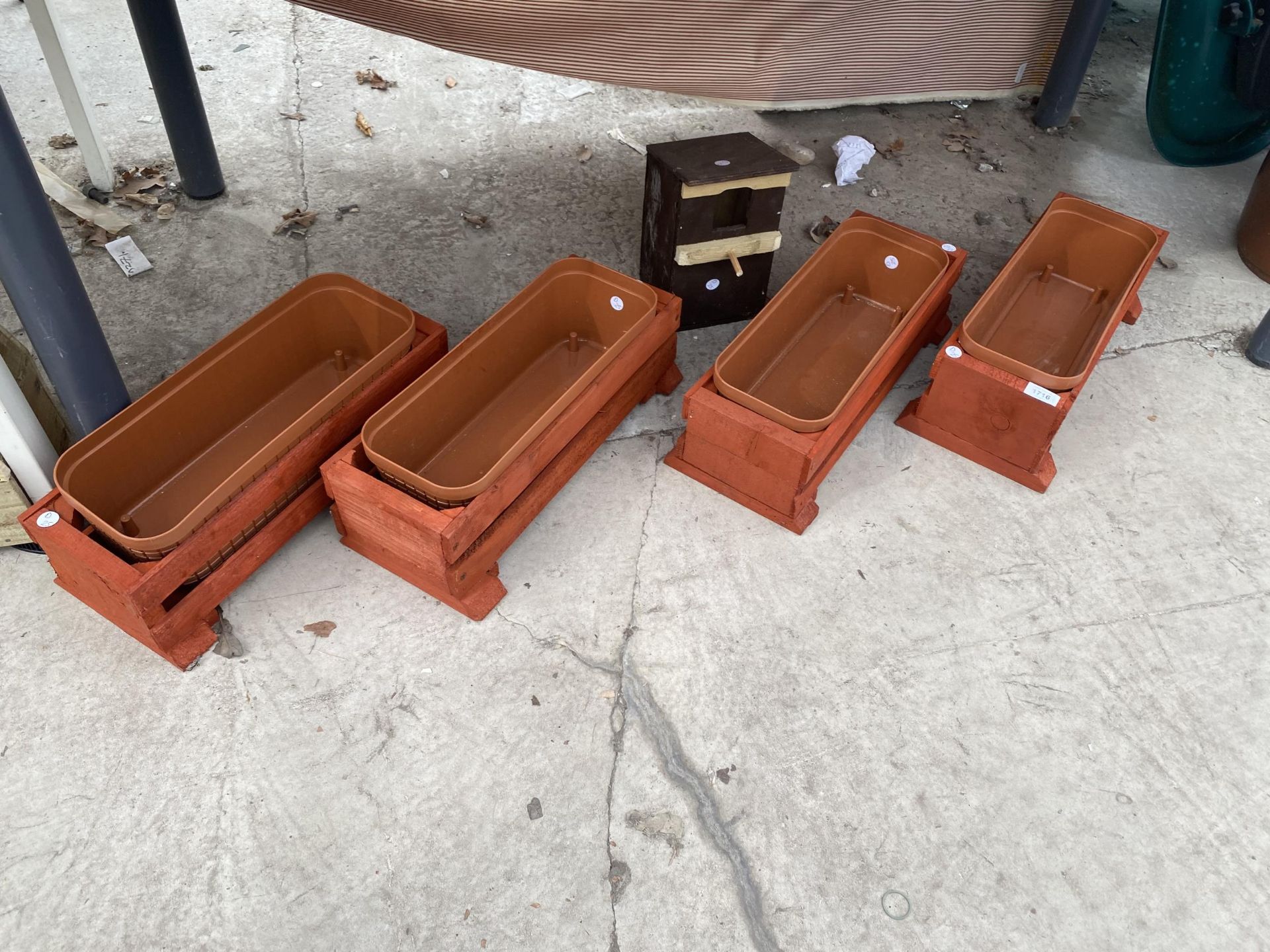 FOUR WOODEN TROUGHS WITH PLASTIC LINERS AND A BIRD BOX