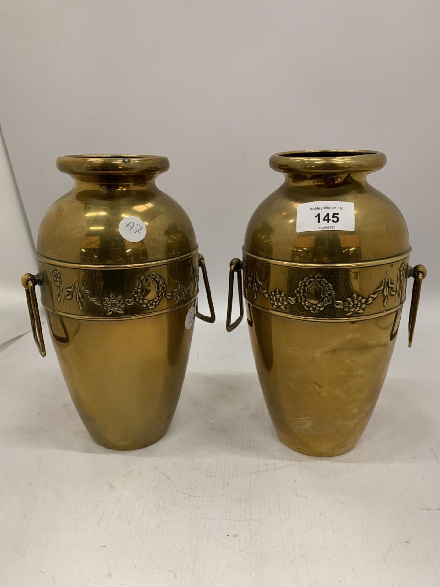 A PAIR OF ART NOUVEAU DESIGN BELDRAY BRASS VASES WITH SIDE HANDLES AND EMBOSSED DECORATION HEIGHT