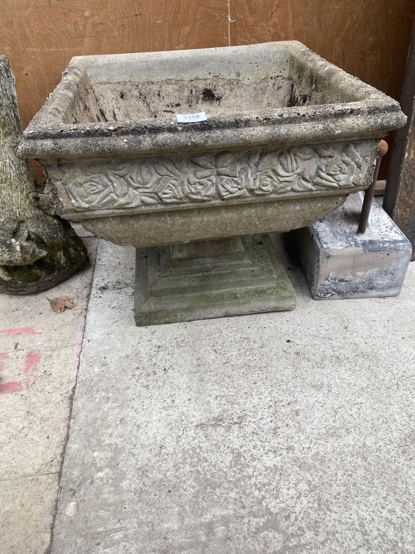 A LARGE SQUARE RECONSTITUTED STONE PLANTER WITH PEDESTAL BASE