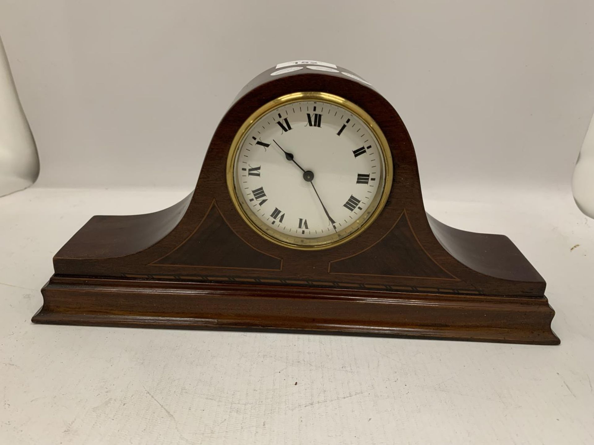 A MAHOGANY CASED WIND UP MANTLE CLOCK