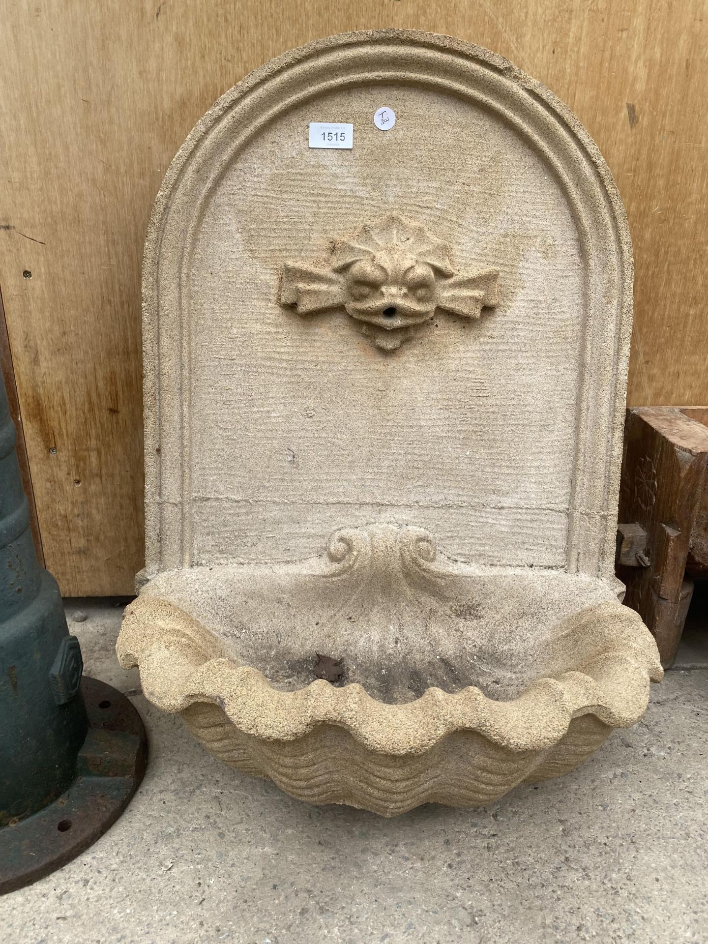 A RECONSTITUTED STONE WALL PLAQUE WATER FOUNTAIN