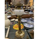 A VINTAGE BRASS OIL LAMP WITH COLUMN STAND AND OPAQUE GLASS HEIGHT 51CM