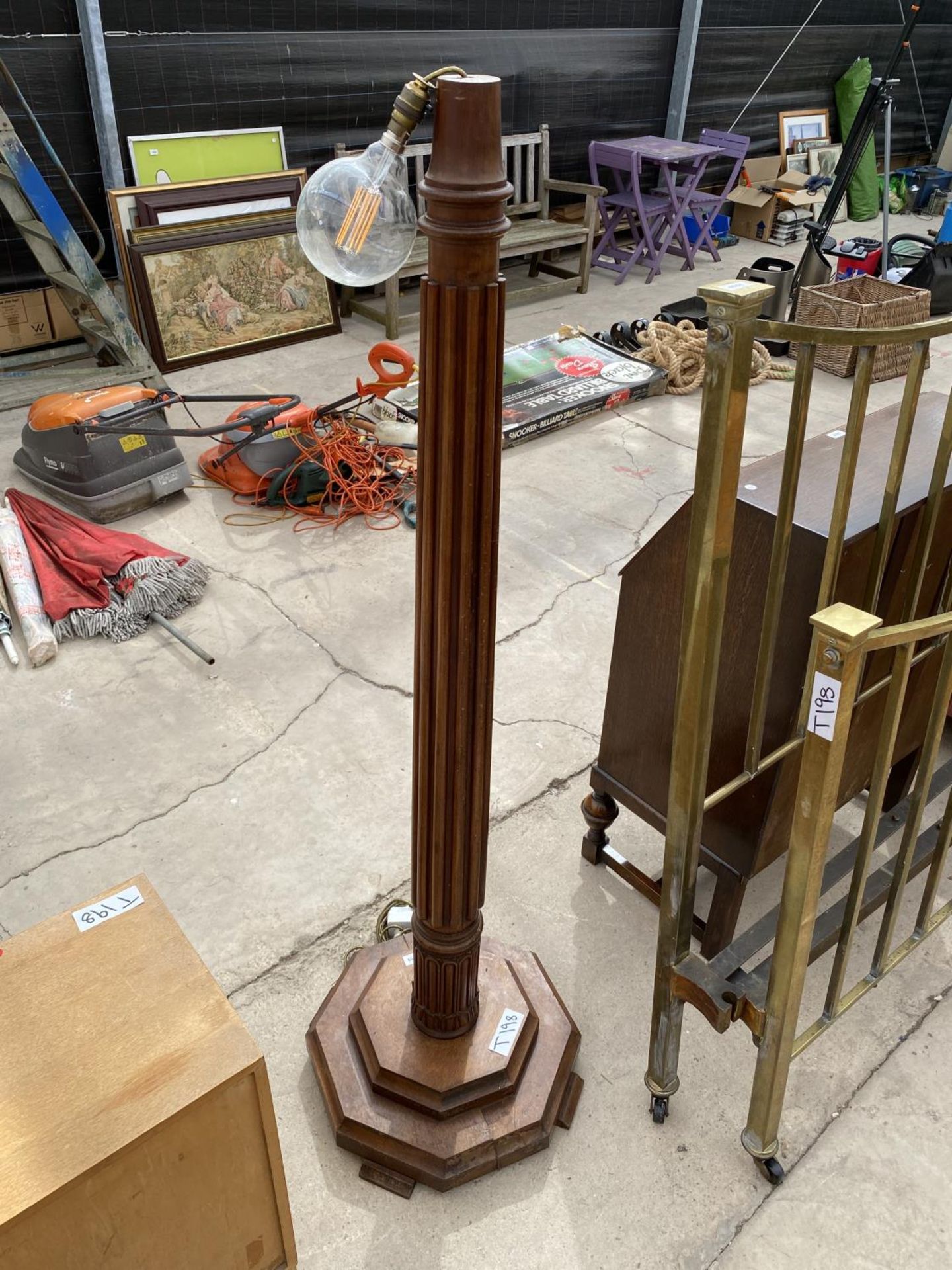 A MAHOGANY STANDARD LAMP ON TAPERED AND FLUTED COLUMN, ON STEPPED BASE