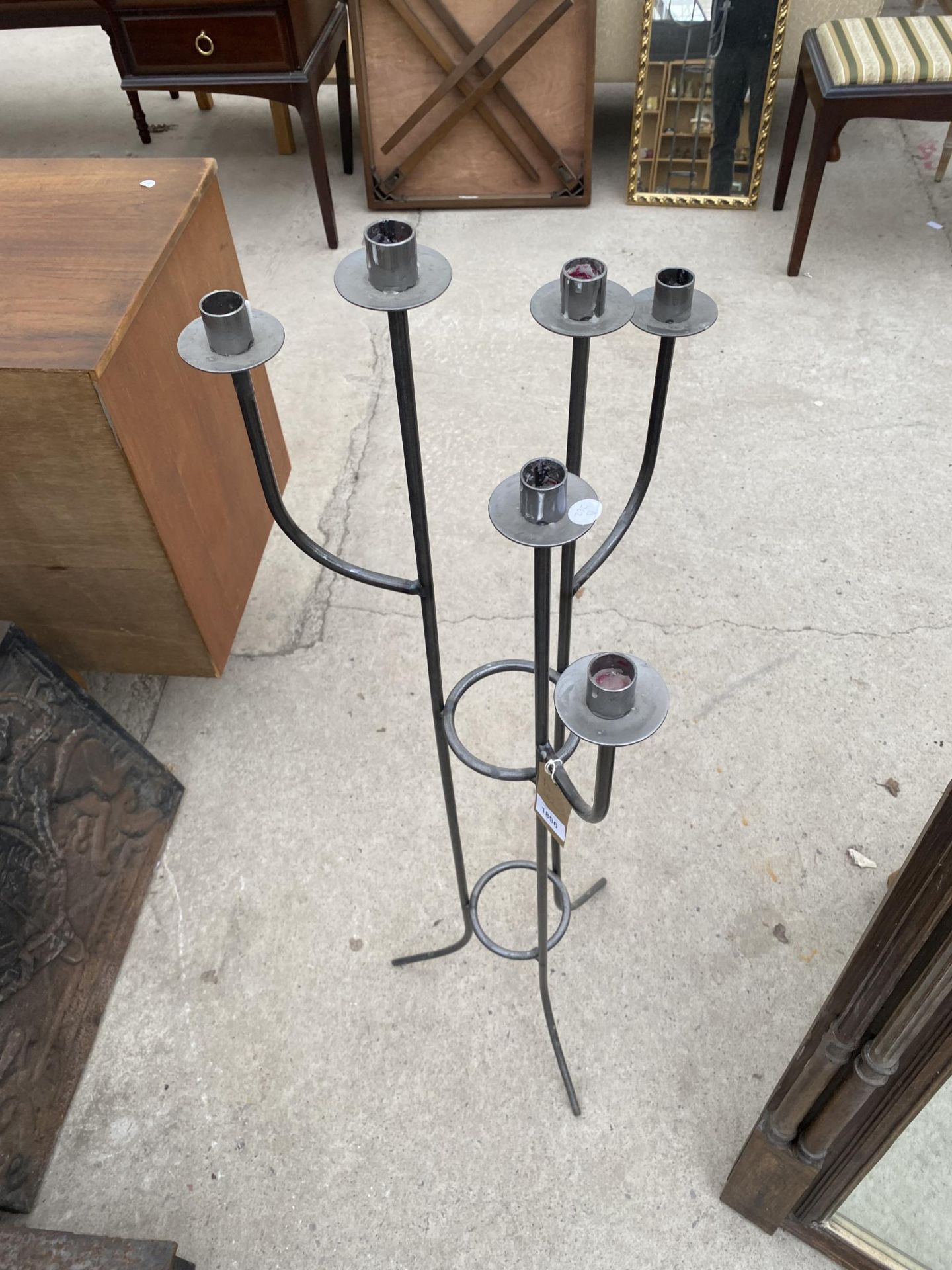 A TALL METAL SIX BRANCH CANDLE HOLDER