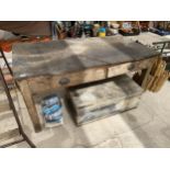 A VINTAGE WOODEN WORK BENCH WITH TWO DRAWERS
