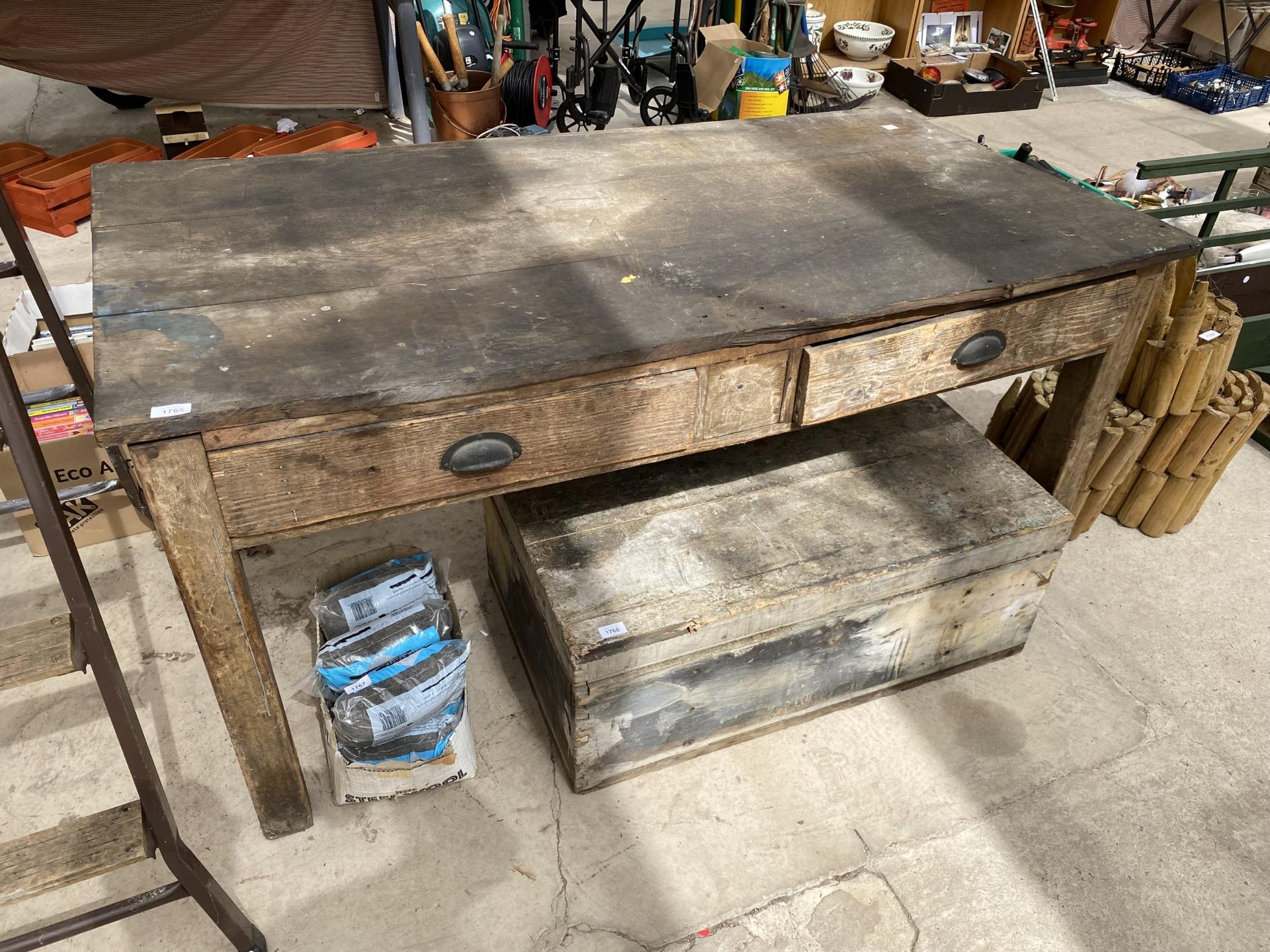 A VINTAGE WOODEN WORK BENCH WITH TWO DRAWERS