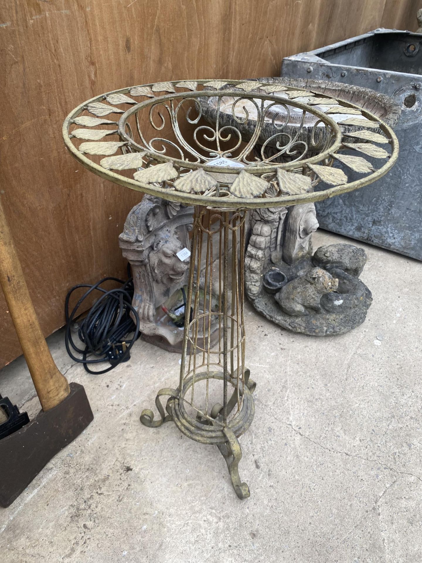 A DECORATIVE METAL PLANT STAND