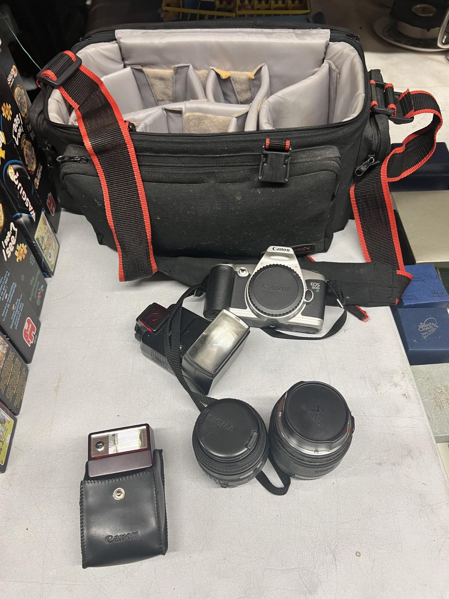 A CANON EOS 500 CAMERA WITH TWO EXTRA LENSES, TWO FLASHES AND A CAMERA BAG