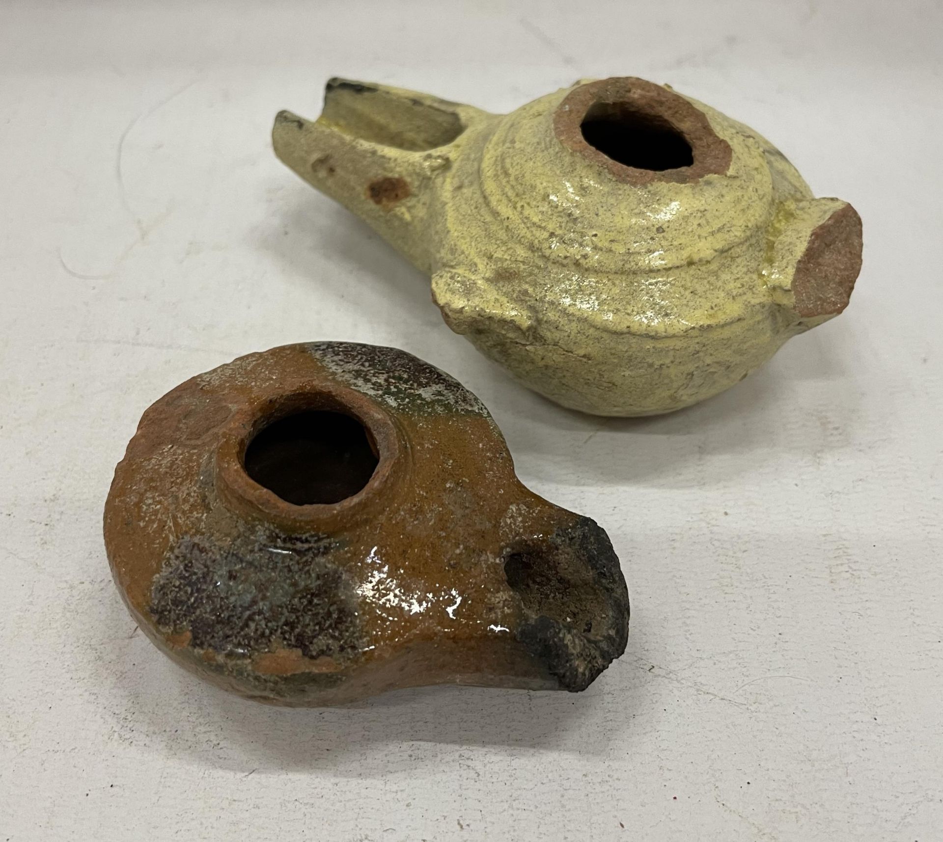 A PAIR OF FATAMID CALIPHATE PERIOD (C.900-1100 AD) GLAZED OIL LAMPS UNEARTHED IN 1926 ARCHAEOLOGICAL