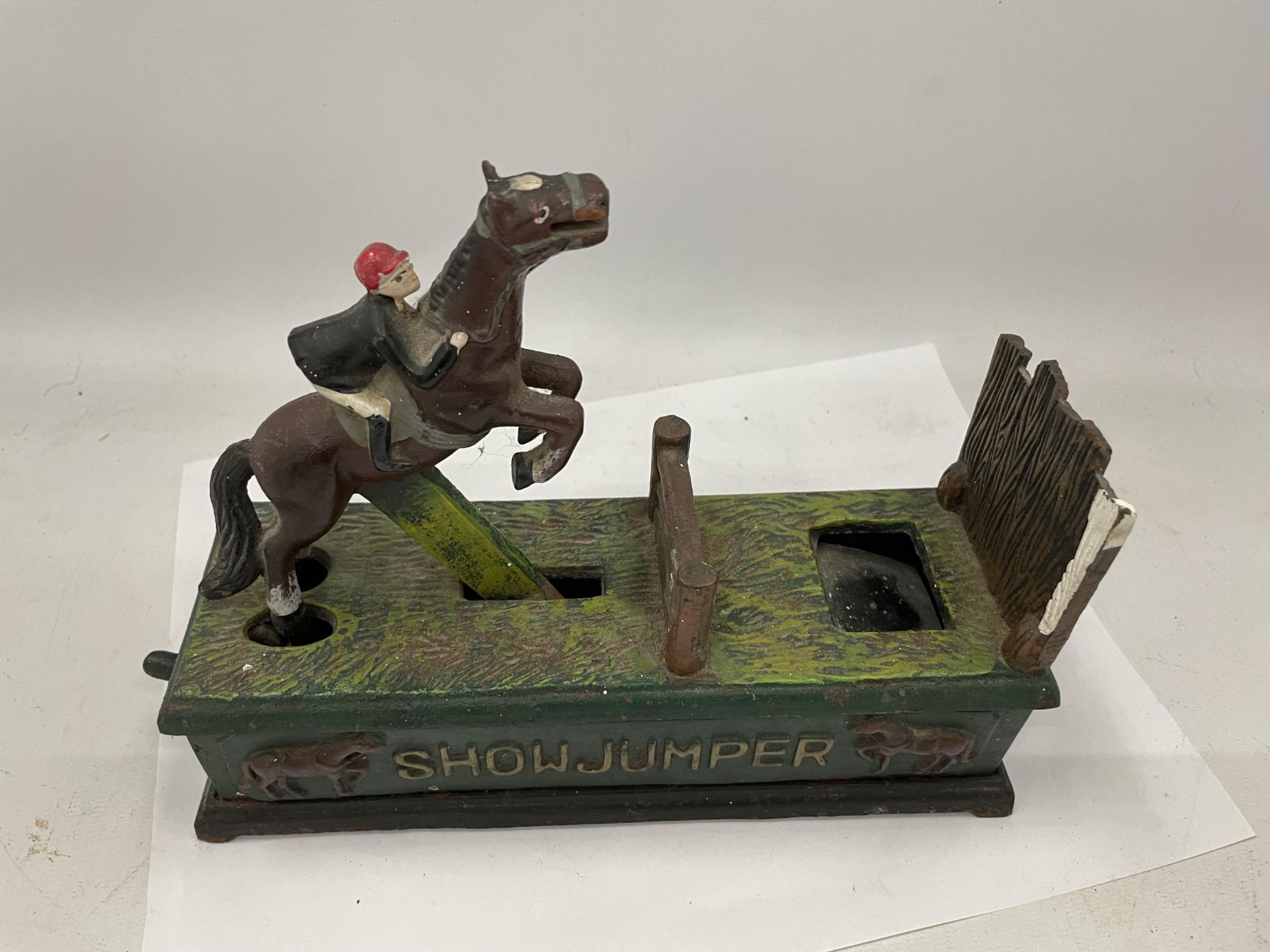 A CAST METAL SHOW JUMPER MONEY BOX