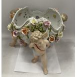 A CONTINENTAL PORCELAIN CHERUB DESIGN FLORAL ENCRUSTED BOWL WITH MEISSEN BLUE CROSS SWORDS MARK TO