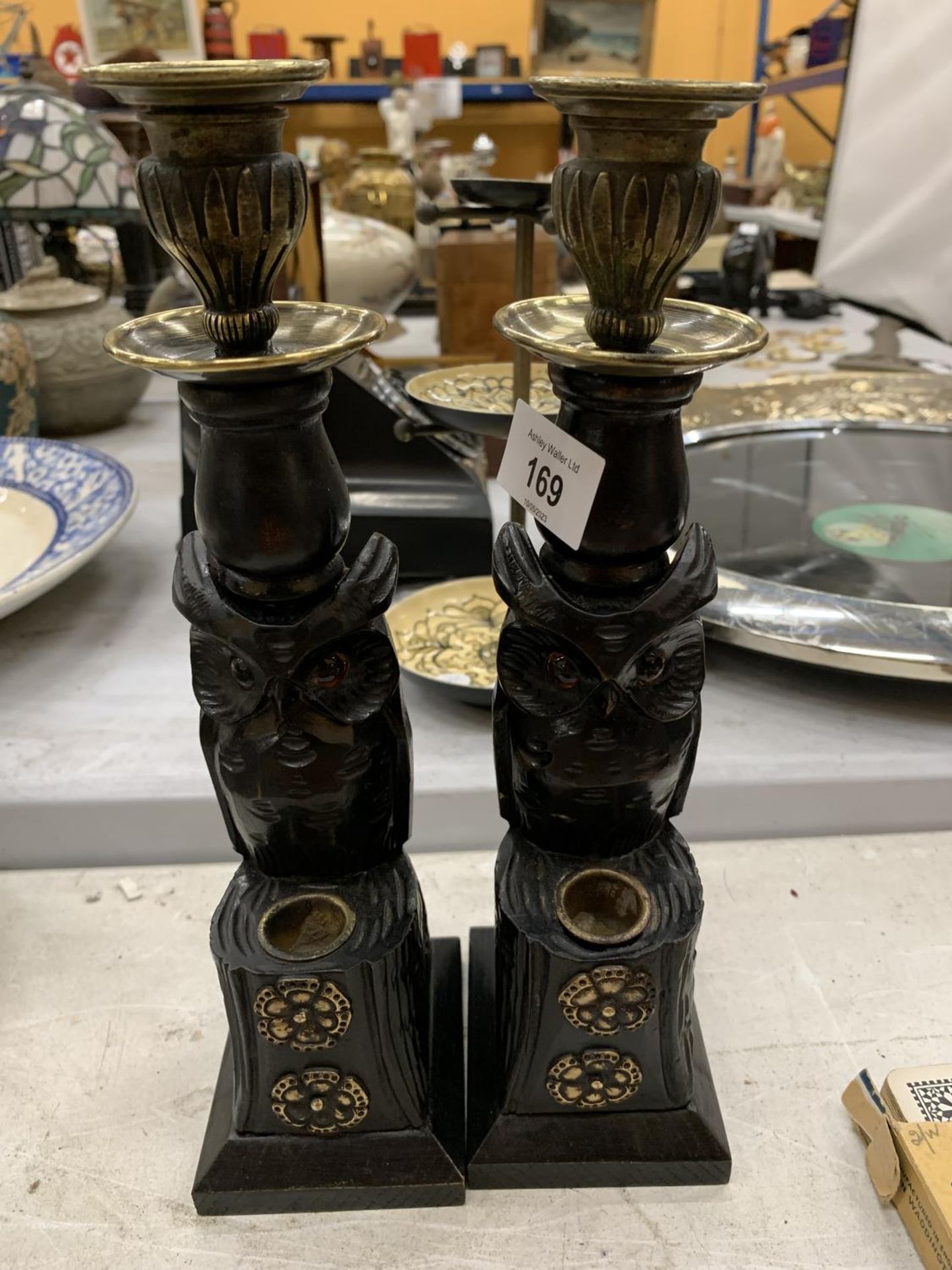 A PAIR OF BRASS AND CARVED WOODEN OWL CANDLESTICKS HEIGHT 27CM