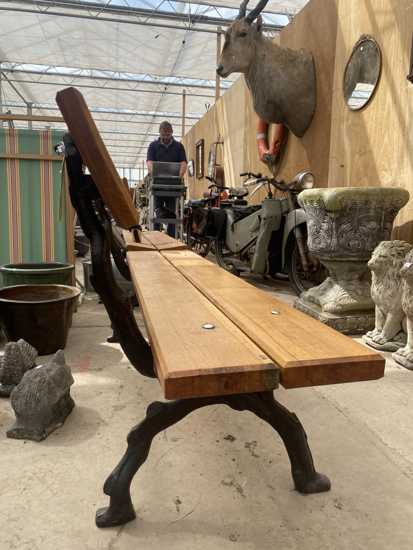 A LARGE REFURBISHED WOODEN SLATTED BENCH WITH 'KNOTTY' CAST IRON BENCH ENDS - Image 2 of 2