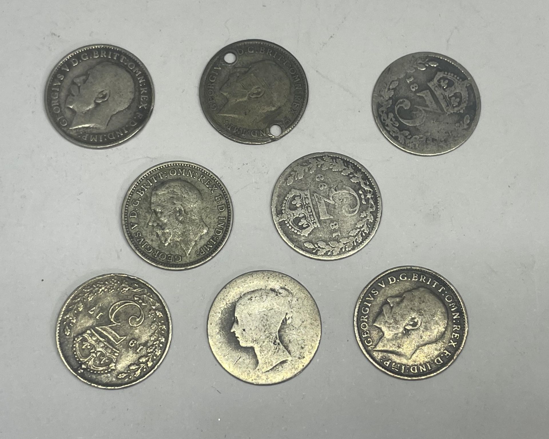 EIGHT SILVER THREE PENCE PIECES