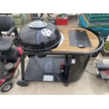 A BLOOMA KINLEY KETTLE CHARCOAL BBQ WITH TROLLEY AND SHELF