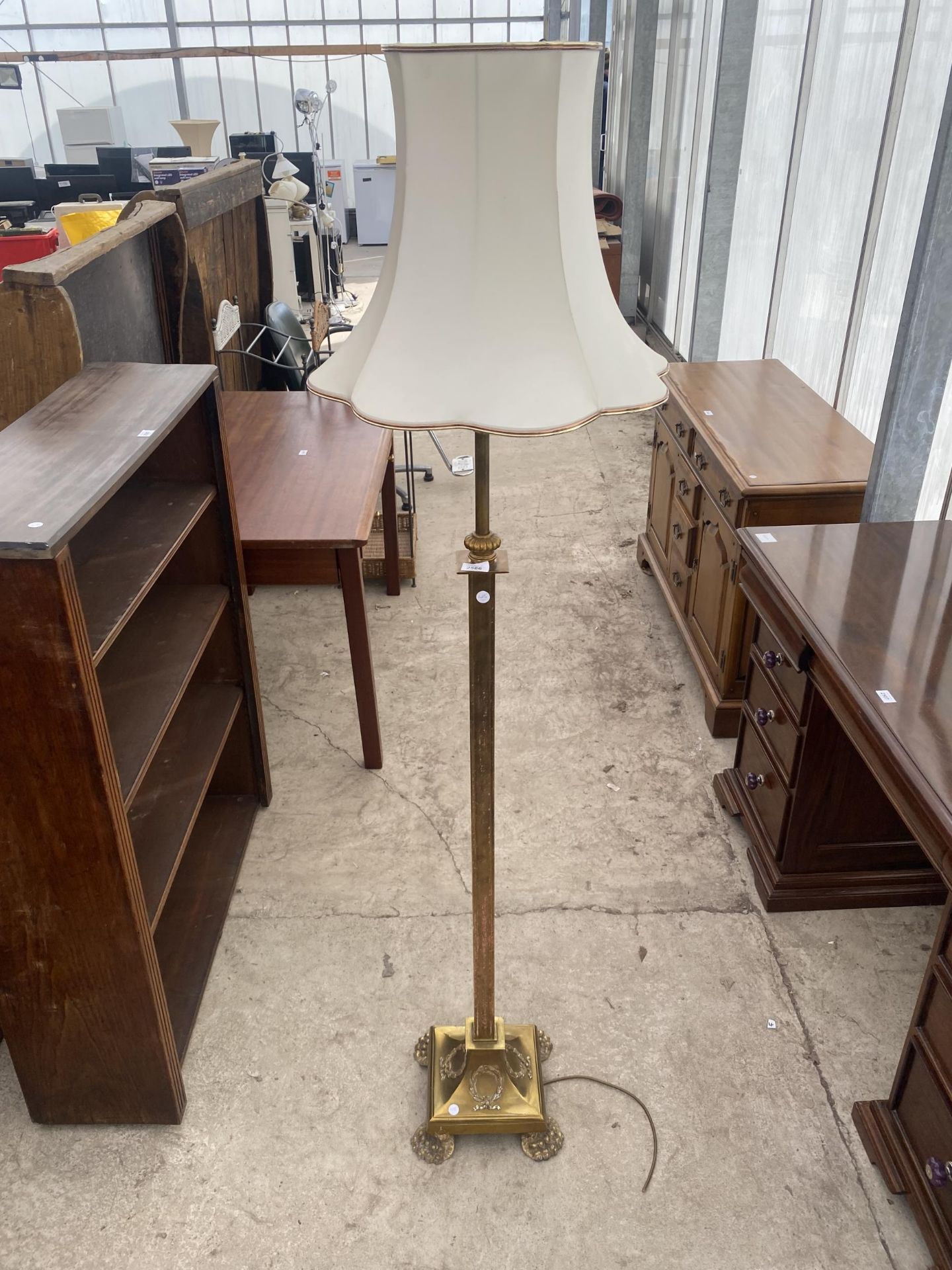 AN ADJUSTABLE BRASS STANDARD LAMP ON SQUARE BASE, WITH CLAW FEET, COMPLETE WITH SHADE