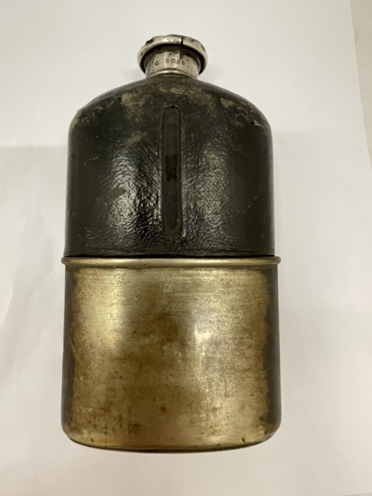 A VICTORIAN HIP FLASK WITH HALLMARKED SILVER TOP, LEATHER TOP HALF AND SILVER PLATED DETACHABLE CUP