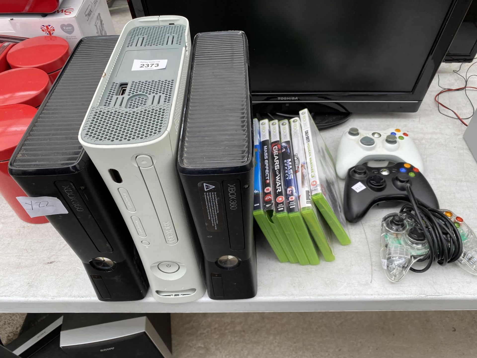 THREE XBOX 360'S, THREE CONTROLLERS AND AN ASSORTMENT OF GAMES