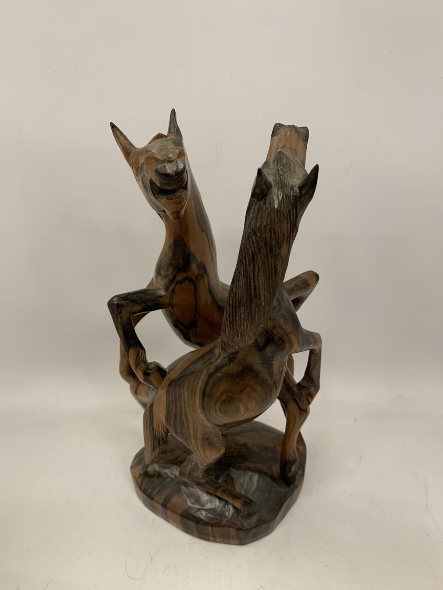 A TREEN CARVING OF FIGHTING HORSES HEIGHT 26CM