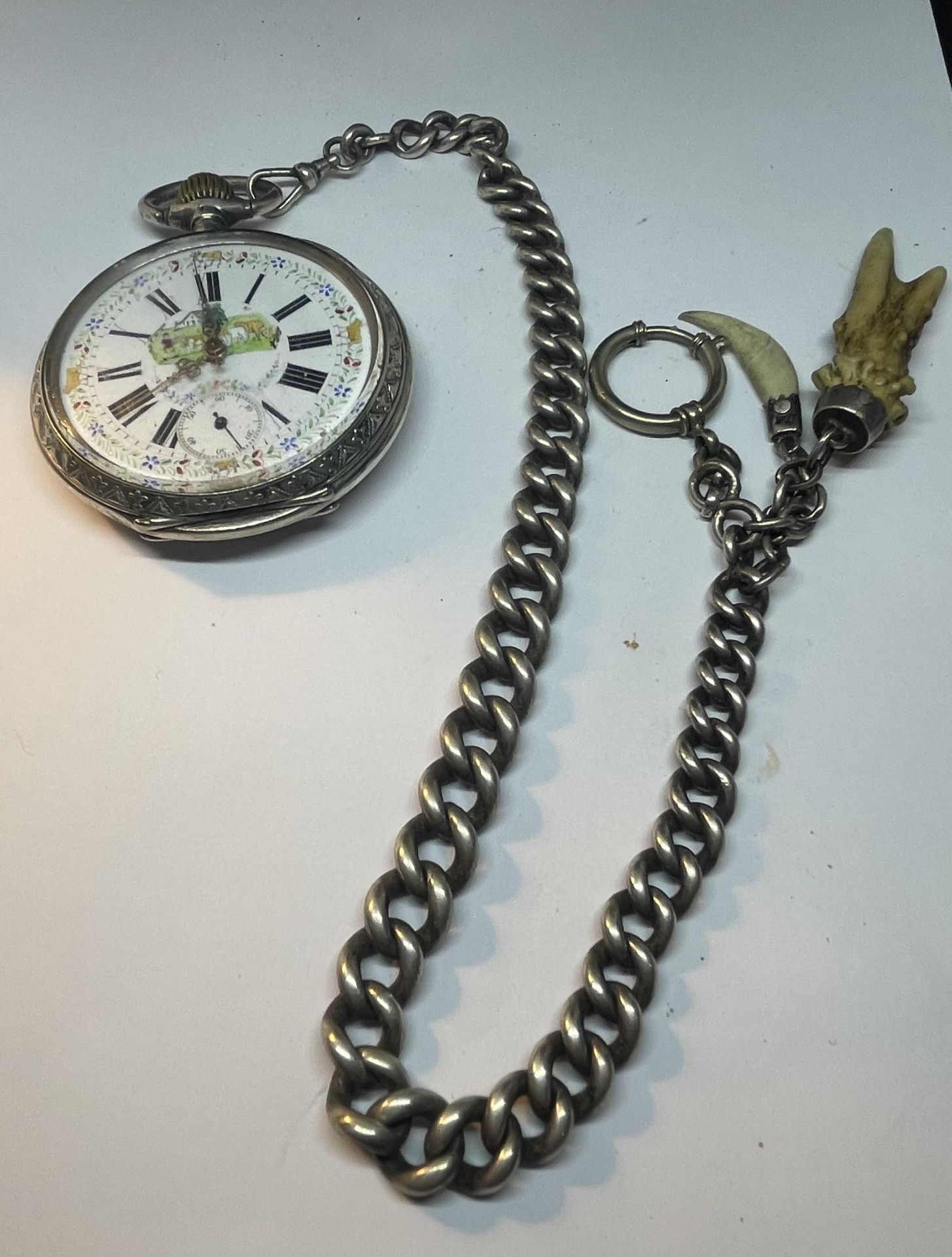 AN ANTIQUE .800 SILVER GOLIATH POCKET WATCH WITH A .830 SILVER CHAIN, SEEN WORKING BUT NO WARRANTIES