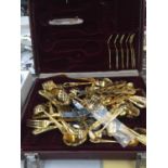 A YELLOW METAL CANTEEN OF CUTLERY IN A CASE