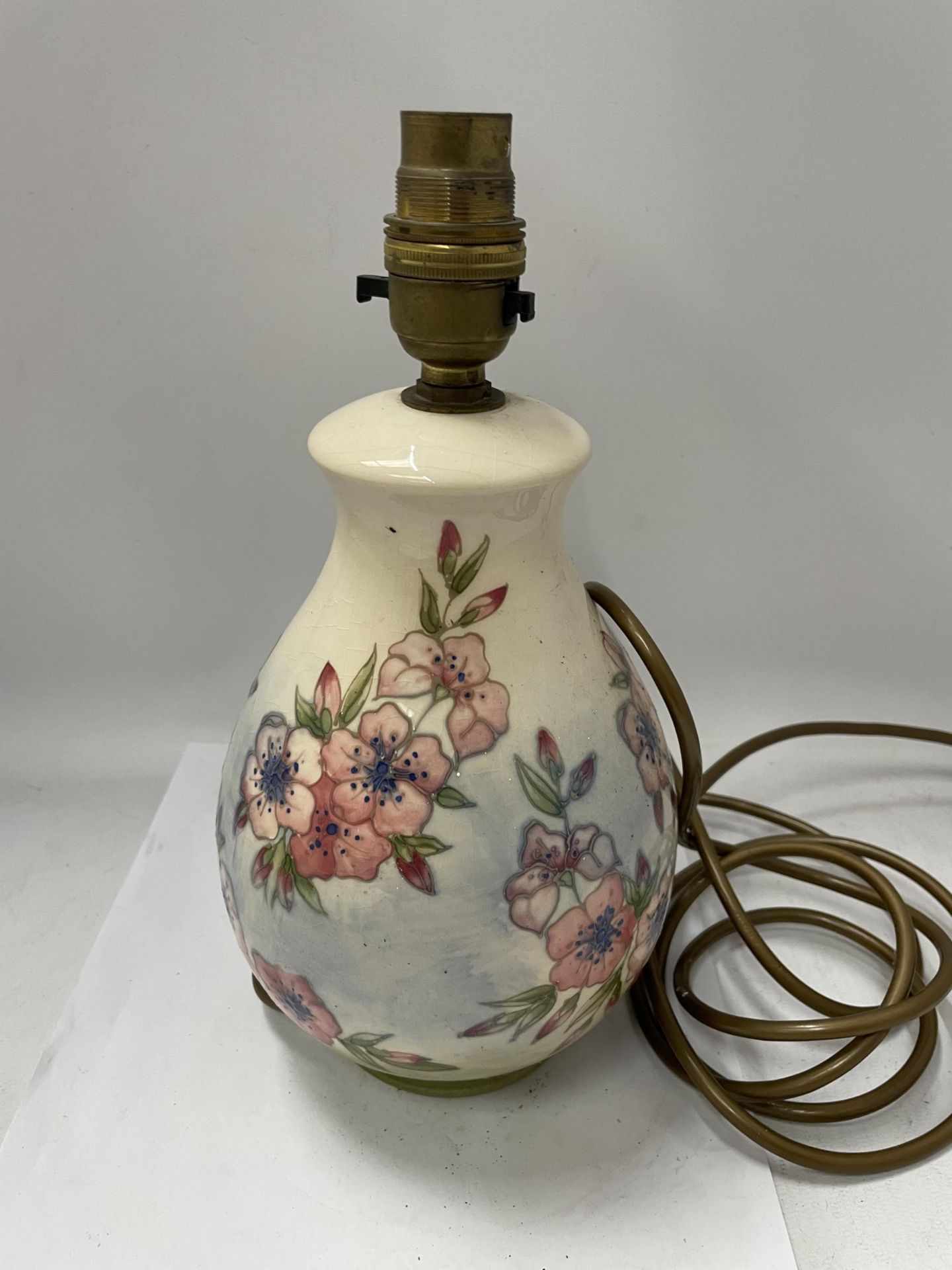 A MOORCROFT POTTERY LAMP DECORATED IN THE 'SPRING BLOSSOM' PATTERN BY DESIGNER SALLY TUFFIN