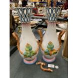 A PAIR OF TWIN HANDLED CONTINENTAL VASES, HANDLE A/F