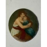 AN ENAMEL DISC OF A MOTHER AND CHILD