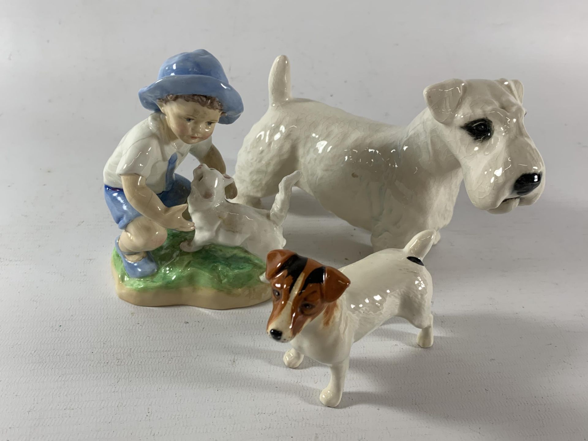 TWO BESWICK DOGS AND A ROYAL WORCESTER SEPTEMBER BOY FIGURE (A/F)