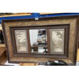 A VINTAGE CARVED WOODEN FRAMED MIRROR WITH SIDE PANELS OF CATTLE