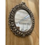 A DECORATIVE SILVER GILT FRAMED WALL MIRROR