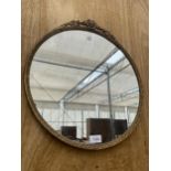 A DECORATIVE CIRCULAR BRASS FRAMED WALL MIRROR