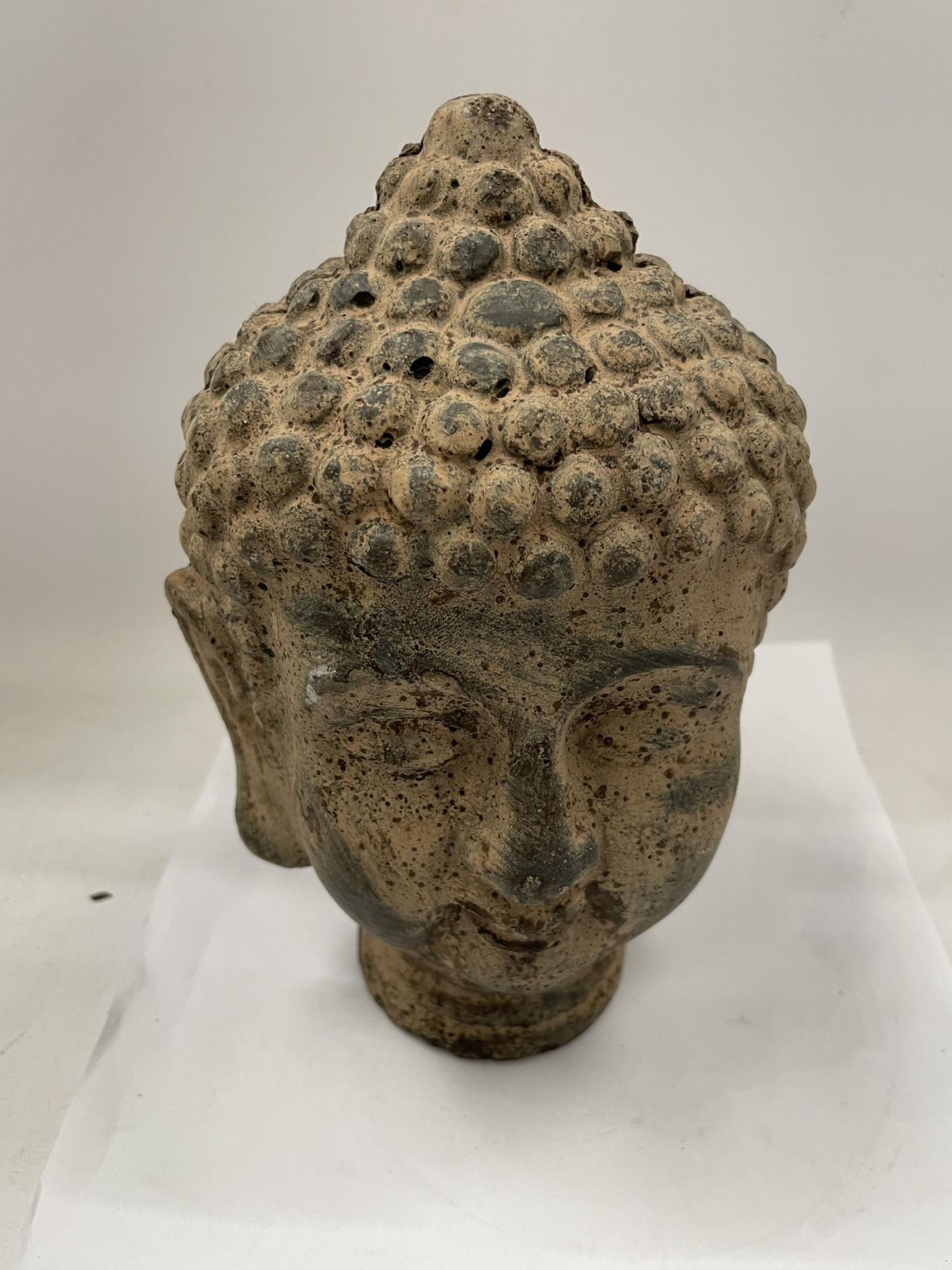 A DECORATIVE STONE BUDDHA HEAD