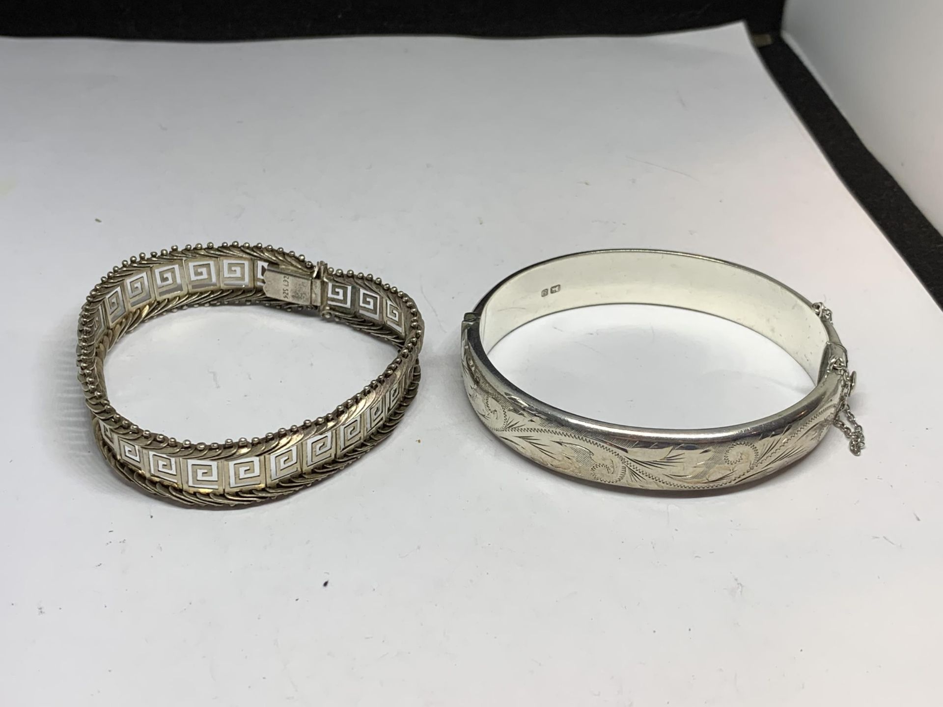 TWO MARKED SILVER BRACELETS TO INCLUDE A HALLMARKED BIRMINGHAM BANGLE AND A GREEK DESIGN EXAMPLE