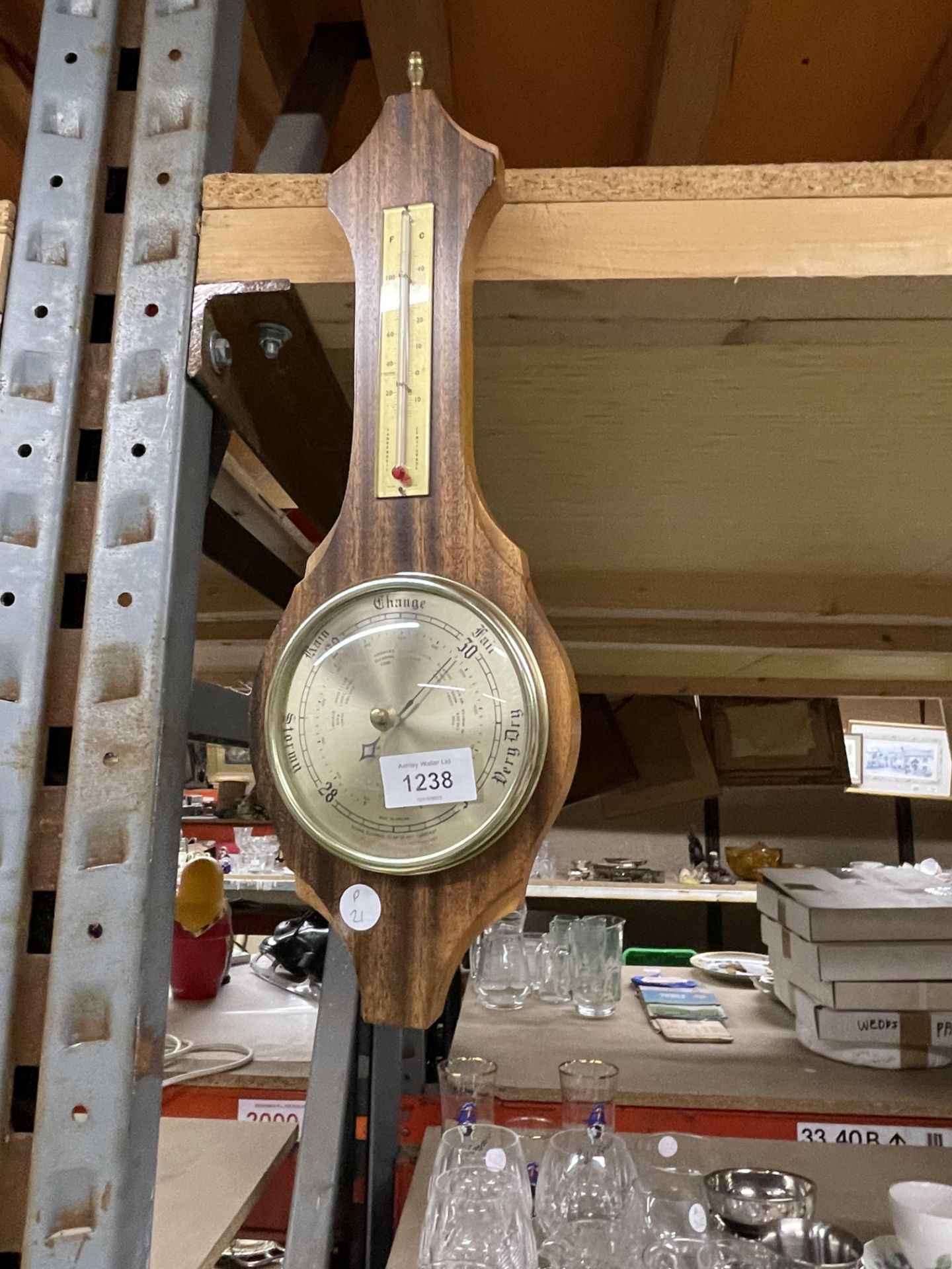 A BAROMETER IN A WOODEN FRAME