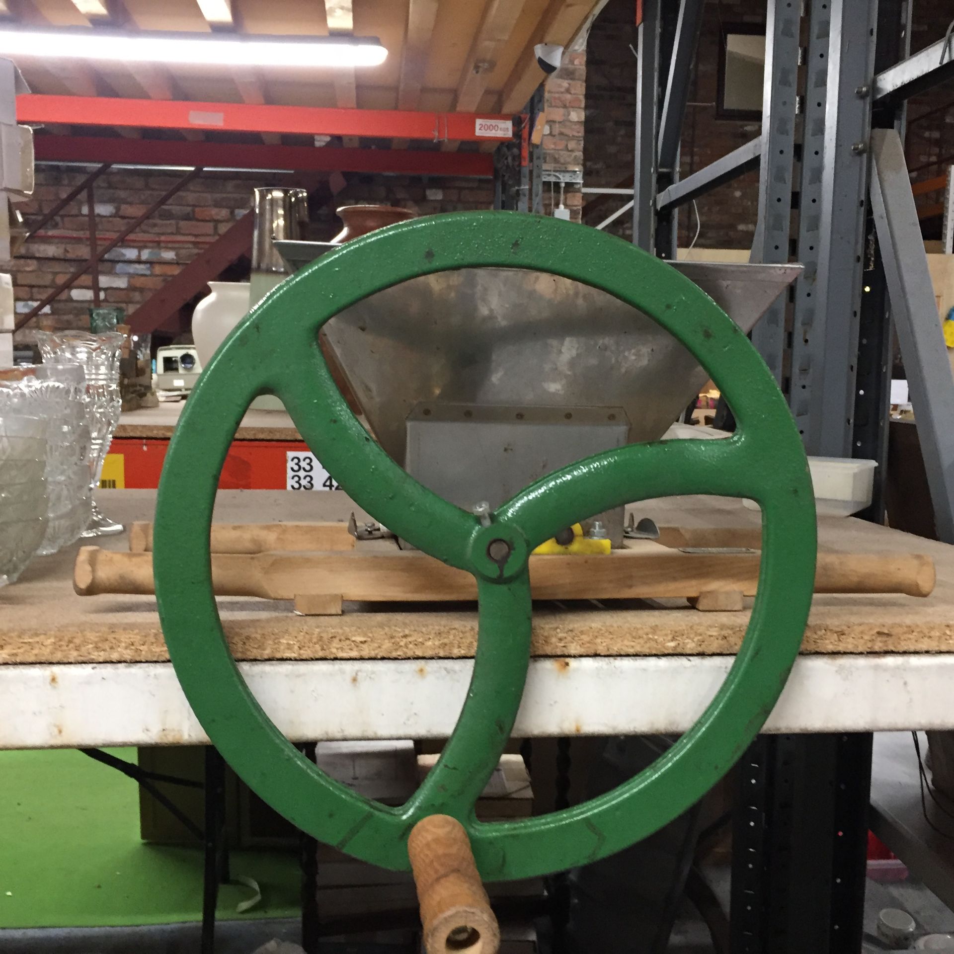 A VINTAGE VIGO APPLE CRUSHER WITH CAST IRON WHEEL