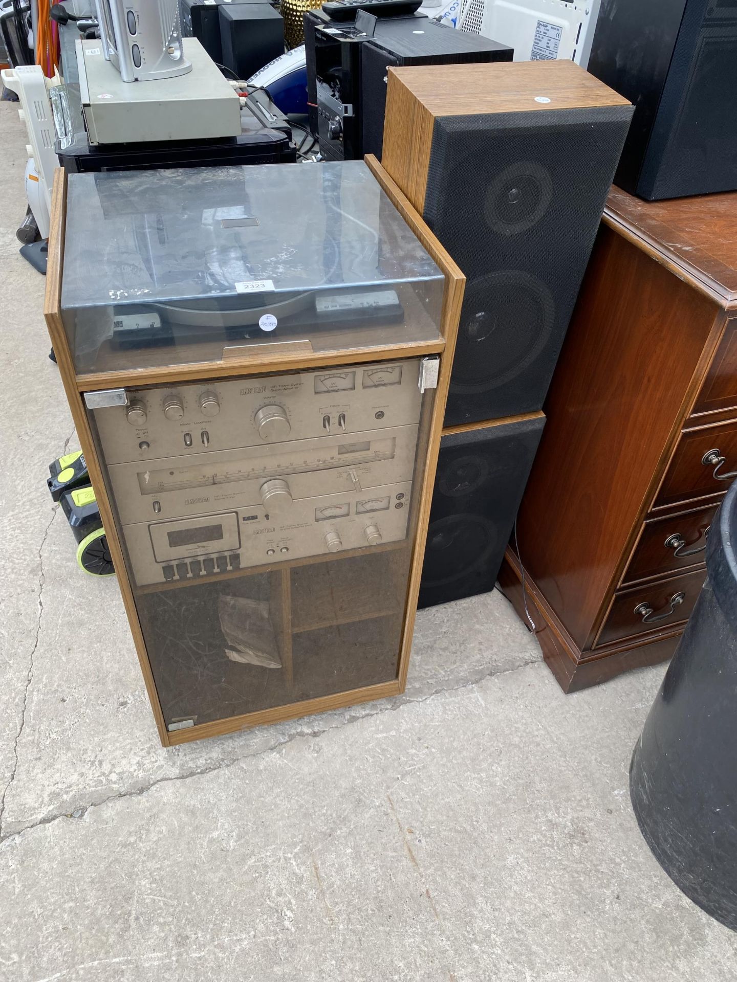 A TEAK RECORD CABINET WITH AN ASSORTMENT OF AMSTRAD STEREO EQUIPMENT AND TWO SPEAKERS