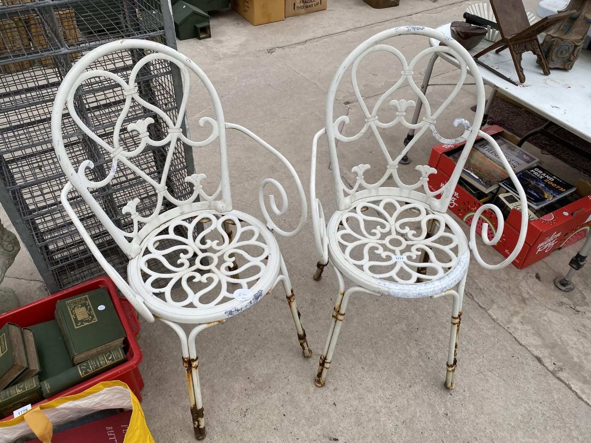 A PAIR OF DECORATIVE WHITE CAST ALLOY BISTRO CHAIRS