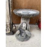 A RECONSTITUTED STONE BIRDBATH WITH PEDESTAL BASE FEATURING ANIMALS AT A TROUGH