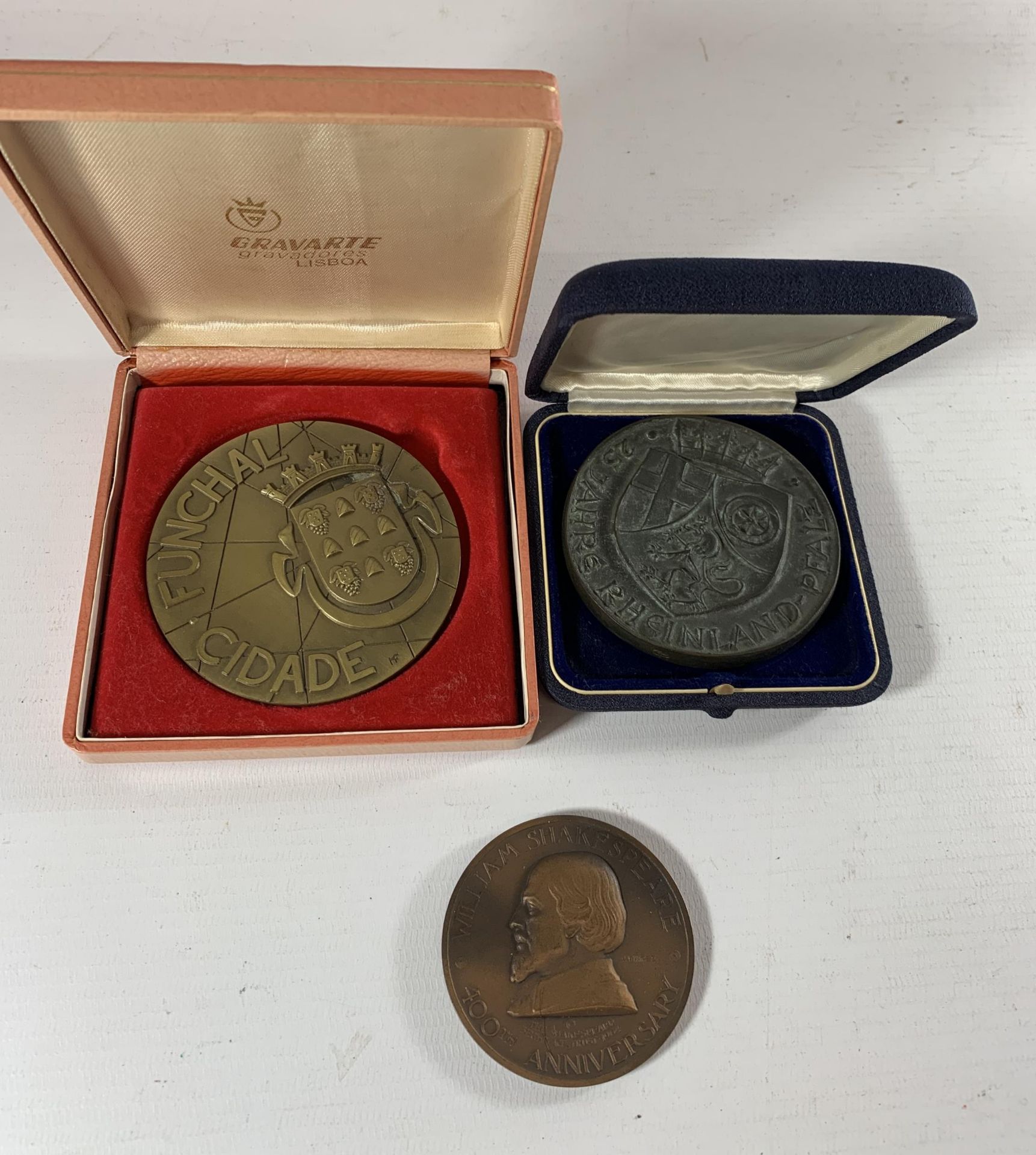 * A LARGE CASED PORTUGUESE BRONZE MEDAL AND A LARGE GERMAN BRONZE MEDAL AND A SHAKESPEARE MEDAL (3)